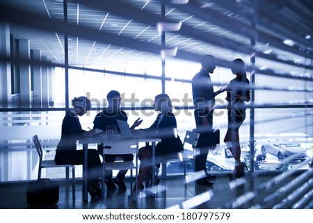 Several silhouettes of businesspeople interacting  background business center Stock foto © 
