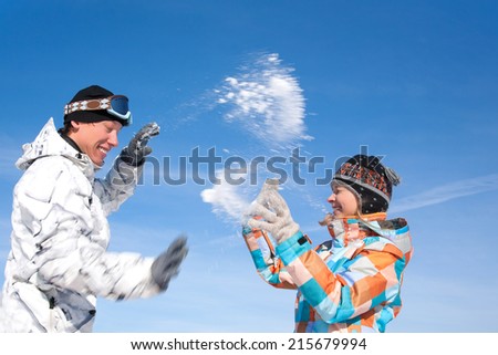 Young playful couple having fun in the snow