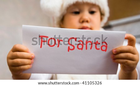 The small child read the letter to Santa