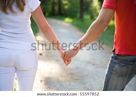 two pairs of hands in love tenderly hold together
