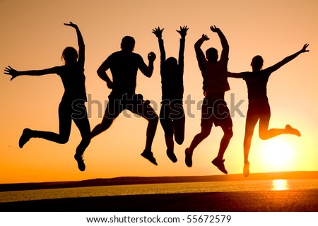 group of happy young people dancing at the beach on beautiful summer sunset - stock photo