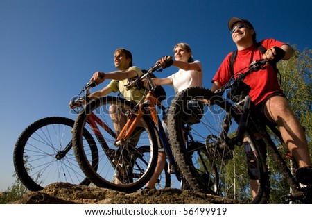 Three  bicycles on the brink of a rock and look afar from rock breakage