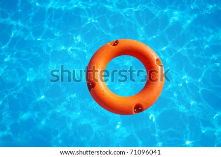 Bright Orange Life Buoy Floating On The Surface Of Blue Water Stock ...