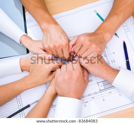 Many hands to stay together over the table to show solidarity team