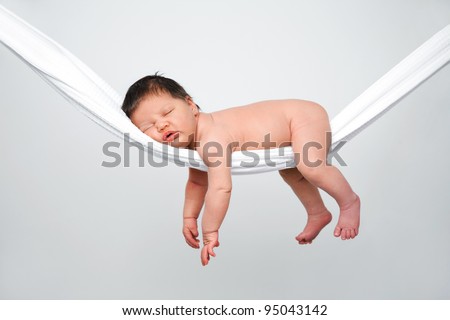 Portrait of funny baby relaxing in hammock