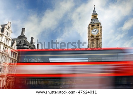 Red London bus passing in front of Big Ben
