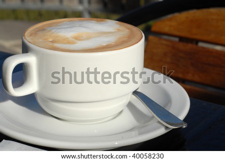 cup hot cappuccino with cream