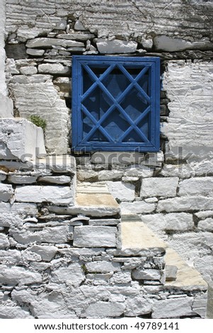 Blue greek window shutters stone stairs and old stone wall