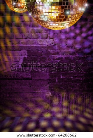 Golden mirror balls reflect lights on dramatic dark disco brick wall