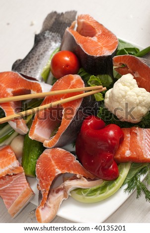 Stake of a salmon with vegetables on a plate