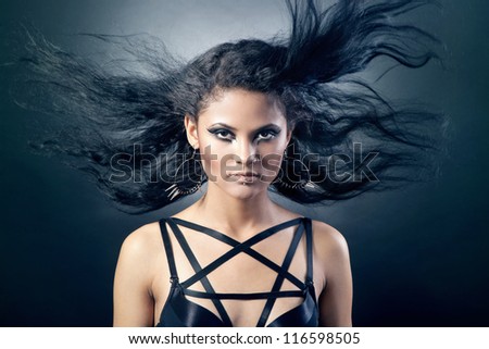 Young Woman's Long black Hair in Motion on a black background