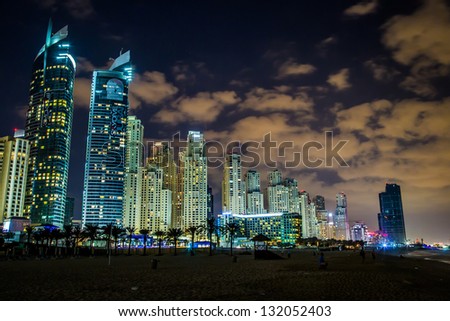 DUBAI, UAE - NOVEMBER 13: Dubai downtown night scene with city lights, luxury new high tech town in United Arab Emirates architecture on November 13, 2012 in Dubai, UAE.  Dubai Marina cityscape, UAE
