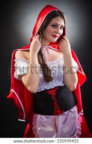 Beautiful woman in carnival costume. Little Red Riding Hood shape. Isolated on black