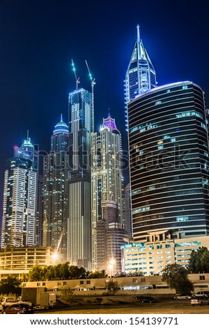 DUBAI, UAE - NOVEMBER 13: Dubai downtown night scene with city lights, luxury new high tech town in middle East, United Arab Emirates architecture. Dubai Marina cityscape, UAE