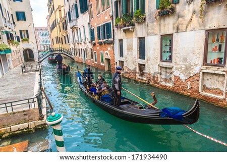 ITALY, VENICE - FEB 7: Gondolier on a gondola on the Grand Canal on February 7, 2013 in Venice. Gondola's are a major mode of touristic transport in Venice, Italy.