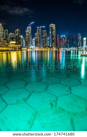 DUBAI, UAE - NOVEMBER 13: Dubai downtown night scene with city lights, luxury new high tech town in middle East, United Arab Emirates architecture on November 13, 2013 in Dubai, UAE