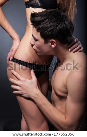 Happy young couple hugging. First love on dark background
