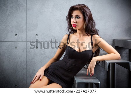 sexy woman lying on stairs at backyard of building