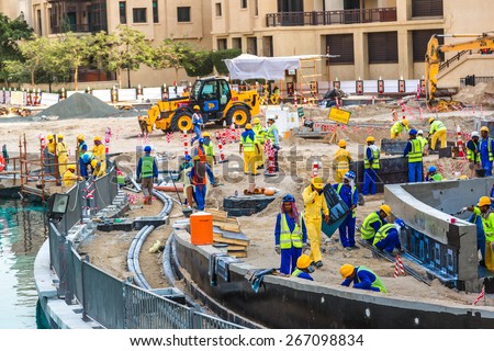 DUBAI, UAE - NOVEMBER 16: Male construction worker in Dubai, on November 16, 2013, Dubai, UAE. Dubai was the fastest developing city in the world between 2002 and 2008.