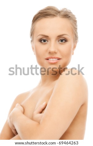 Naked attractive blond woman close her chest by arms