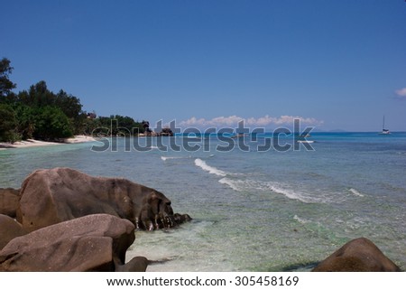 A beach with clean water and sand