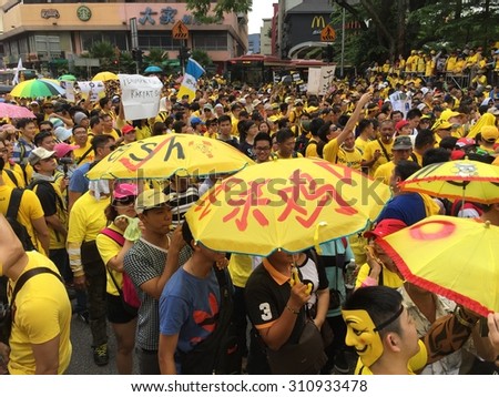 Kuala Lumpur, Malayia 29 August 2015 : Yellow shirt Supporters displays umbrella slogans supporting Bersih Rally for Free Fair Elections. Bersih organized Rallies 29/30 Aug in cities around Malaysia