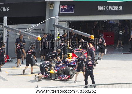 SEPANG, MALAYSIA - MARCH 23: Australian Mark Webber of Team Red Bull pushed back to his pit garage during Friday practice at Petronas Formula 1 Grand Prix March 23, 2012 in Sepang, Malaysia