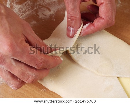 Wrap butter in dough. Bring each corner of the dough to the centre of the butter to enclose it completely. Making Puff Pastry Series.