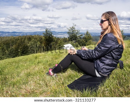 Woman artist working en plein air in mountains.