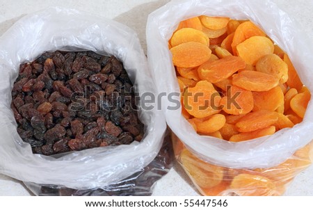 raisins and dried apricots in plastic bag on a table