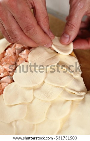 Similar – Image, Stock Photo Filling and sealing puff pastry dumplings in a kitchen