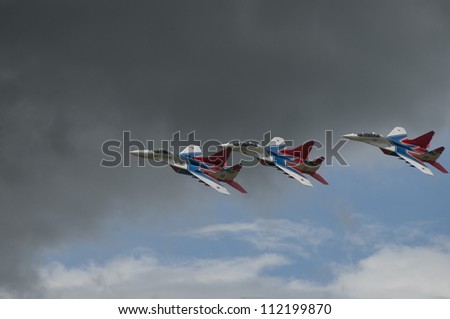 MOSCOW - JUNE 28: Training flights of the flight groups Strizhi and Russian Knights (Russkie Vityazi) on aerodrome Kubinka on June 28, 2012 in Moscow, Russia. Mig-29 group bottom view