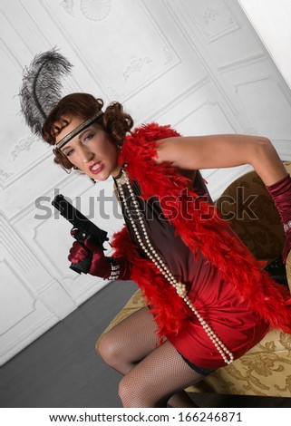 Retro Woman Portrait. Beautiful Woman armed with gun
