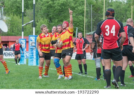 MOSCOW - MAY 13: Players Slava CSP rejoice earned points at Russian Rugby Championship 2014 match between Slava CSP (yellow) and Metallurg (black), on May 13, 2014, in Moscow stadium Slava Russia.