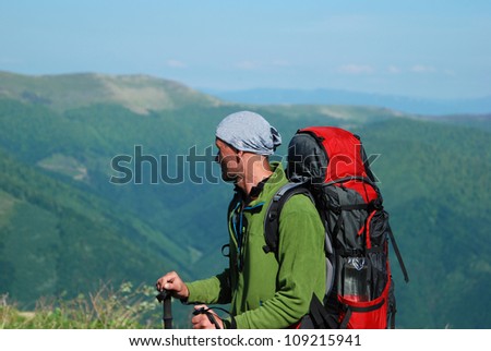 Carpathian Mountains. Hiker with backpack viewing trip