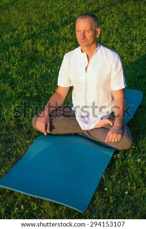 Man practicing yoga in the park. Top view