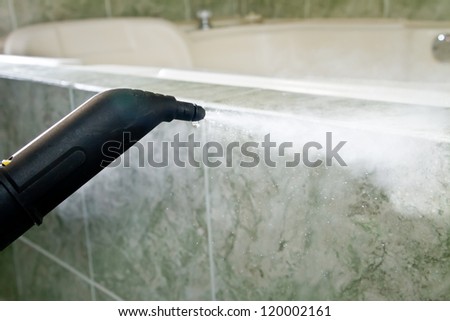 thick stream of fog on a tile wall, cleaning machine nosle