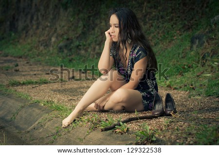 Thinking woman relaxing  in the park thinking on autumn color