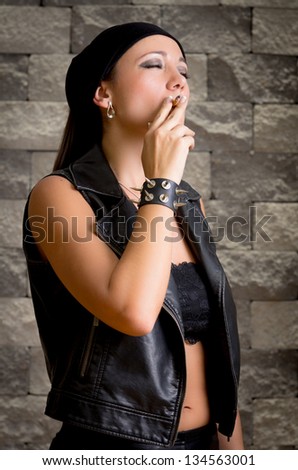 gang woman smokes on the street, selective focus
