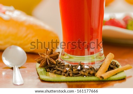 breakfast and glass of red juice on wooden table