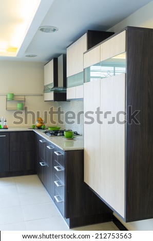 modern bright kitchen with wooden cabinets and white tiles