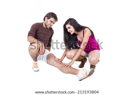 Young man stretching with happy female personal trainer isolated on white