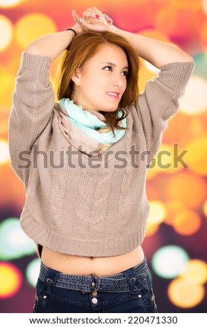 Portrait beautiful young blond girl over colorful background looking to the side