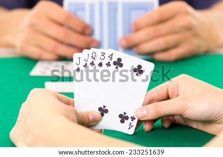 Playing cards closeup of hands holding deck cuarenta traditional Ecuadorian game selective focus
