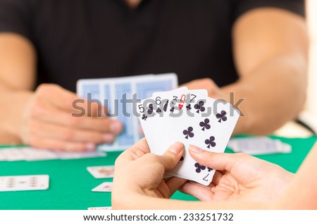 Playing cards closeup of hands holding deck cuarenta traditional Ecuadorian game
