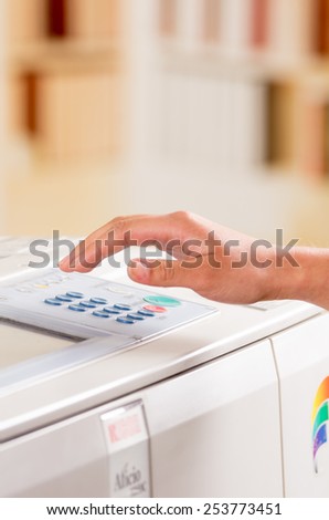 hand of a person using copy machine selective focus