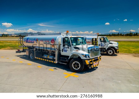 BOGOTA, COLOMBIA - MARCH 07, 2015: Fuel trucks parked in front of aircraft at international airport el Dorado in Bogota Colombia