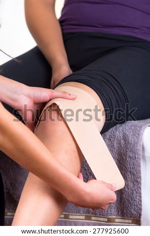 Close up shot of young woman lying while getting an leg massage after injury from specialist concept of physiotherapy