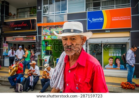 ARMENIA, COLOMBIA - FEBRUARY 23, 2015: Unidentify indigenous man that works in coffee plantation shopping in the main commercial street of Armenia