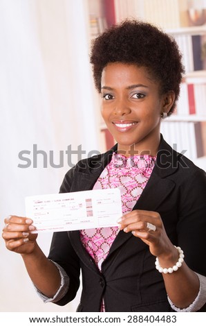 Black office woman showing ticket to camera and smiling concept transport airplane airline bus train traveling airport counter depart flight